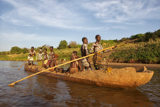 Kara tribe canoeing down the Omo River