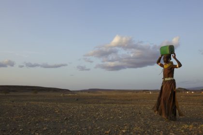Turkana woman carrying water, Northern Kenya