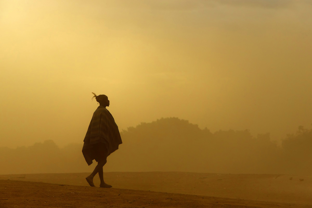 Hamar warrior walking through a dust storm in the Omo Valley