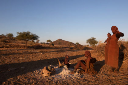 Angola, Himba women with children around the camp fire