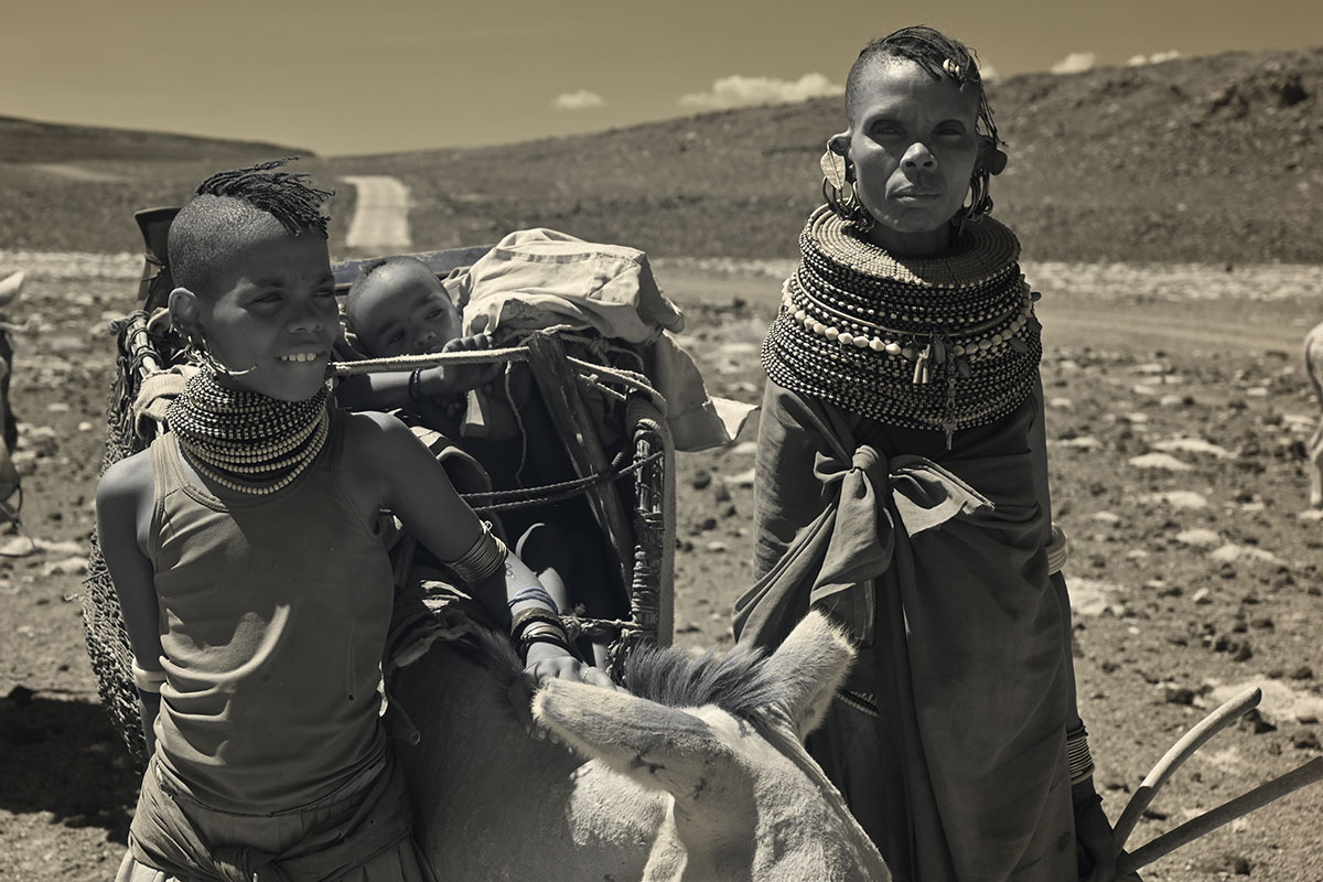 A Turkana woman and children moving nomadically across the Turkana basin during our Tribal Expedition in Northern Kenya