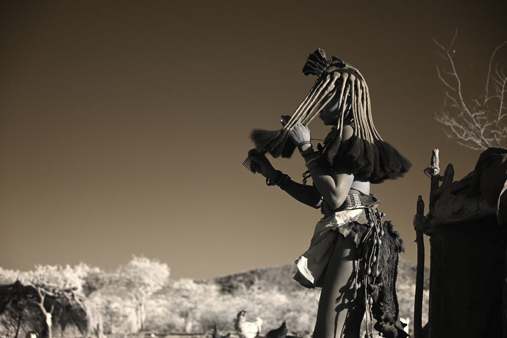 Himba women doing her hair, southern Angola