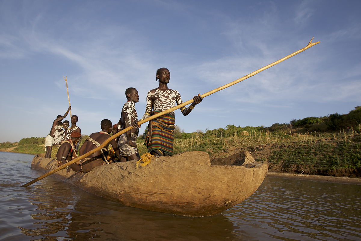 Kara tribe canoeing down the Omo River