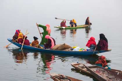 Families Leaving the Dock in their Traditional Wooden Canoes